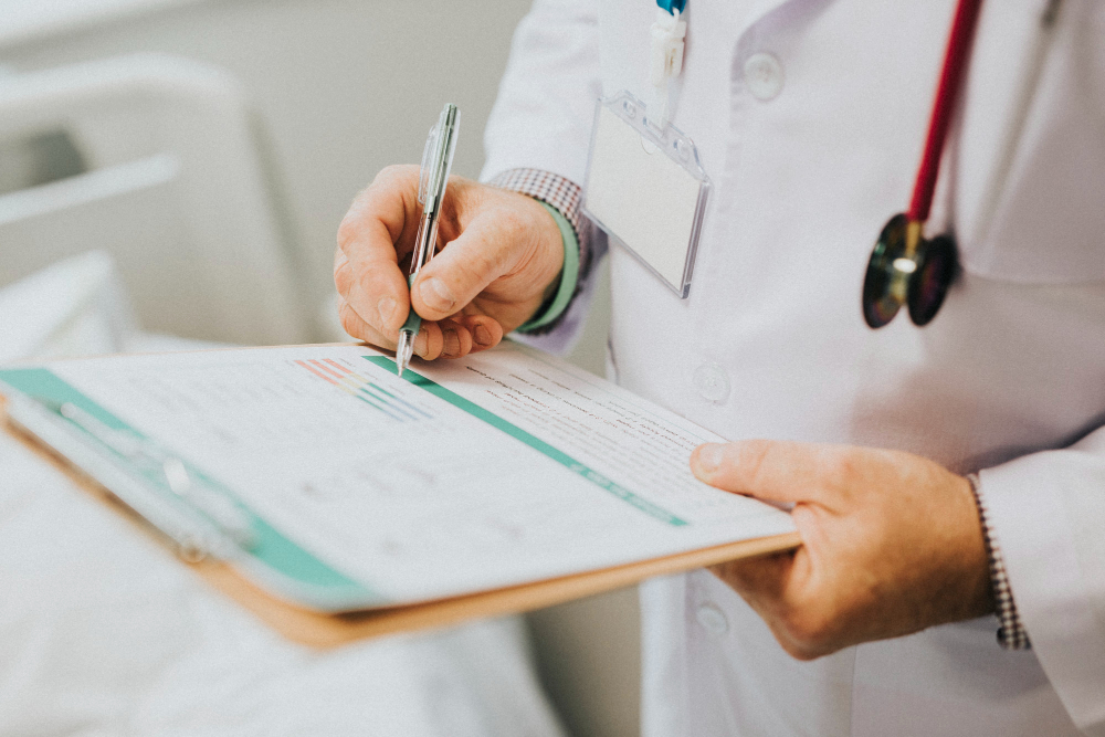 Physician noting symptoms of a patient.